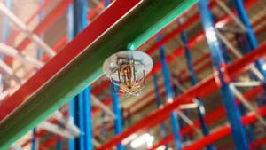 Fire sprinkler system installed in a large warehouse with metal shelving.