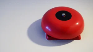 Red fire alarm bell or emergency alert device used during fire emergencies