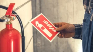 Wall-mounted fire extinguisher in a commercial building hallway