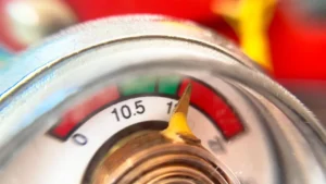 checking the pressure gauge on a fire extinguisher