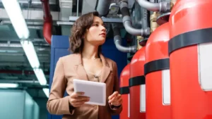 Fire protection professional inspecting commercial fire suppression systems