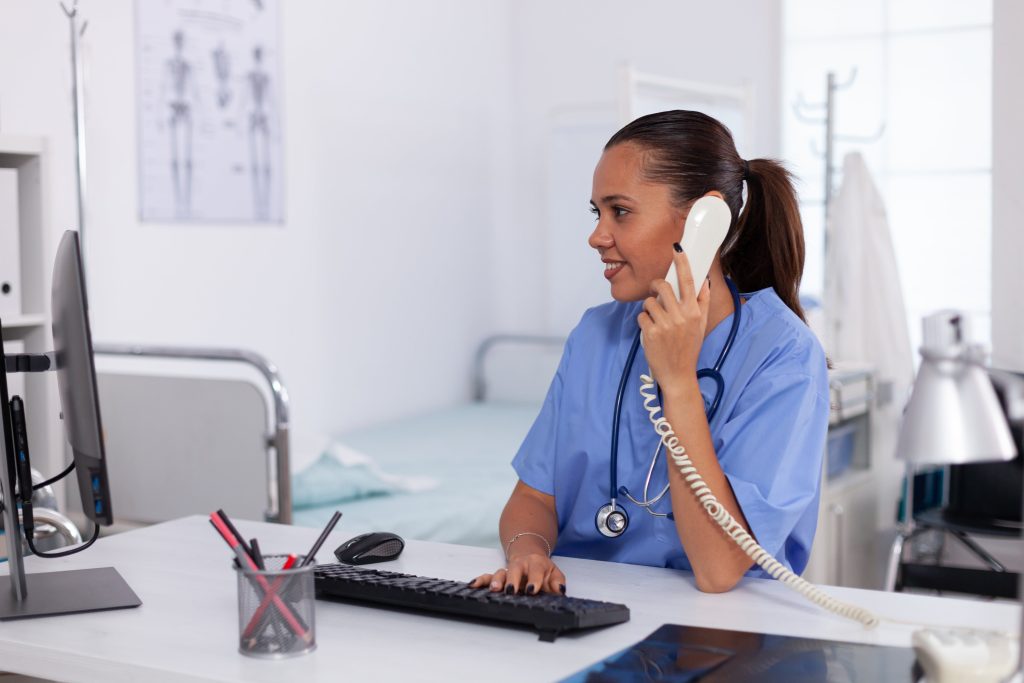 Nurse answering a call using a nurse calling system, ensuring patient assistance