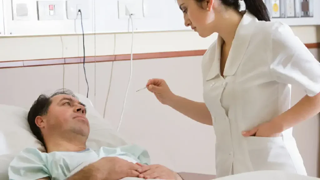 Nurse checking a patient with a nurse call system in a hospital room